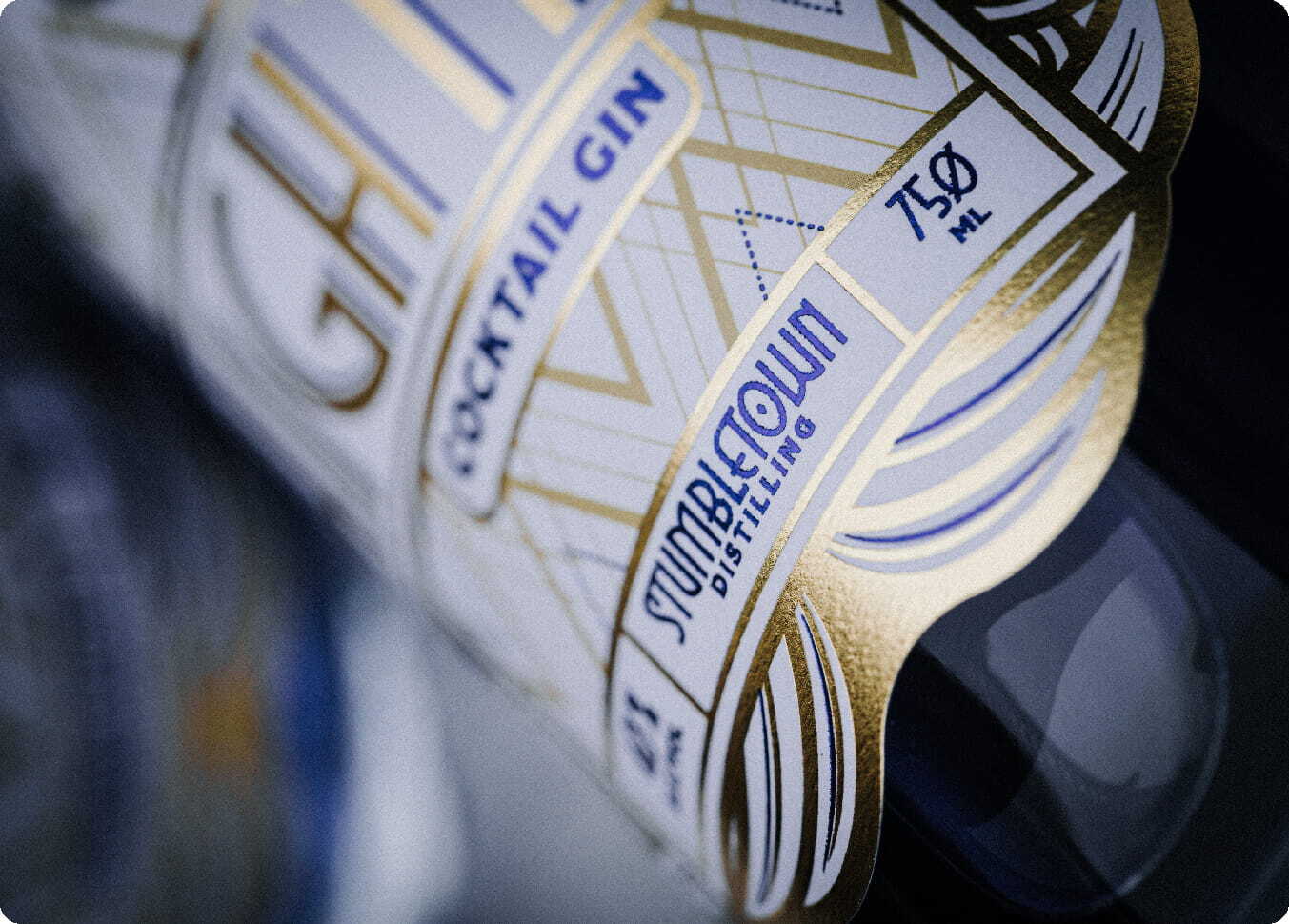 Close-up of a wine bottle with a gold foil-stamped custom label catching the light Close-up of a wine bottle with a gold foil-stamped custom label catching the light